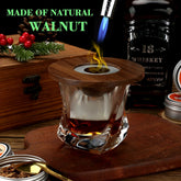 Smoked whiskey cocktail in a clear glass with a walnut wood lid and visible torch flame.