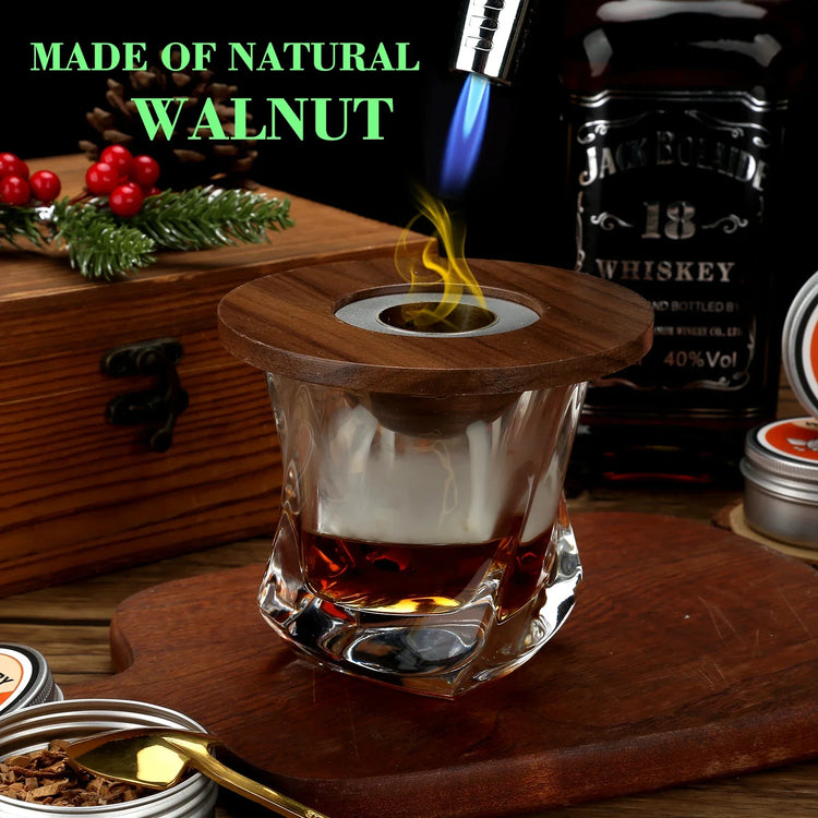 Smoked whiskey cocktail in a clear glass with a walnut wood lid and visible torch flame.