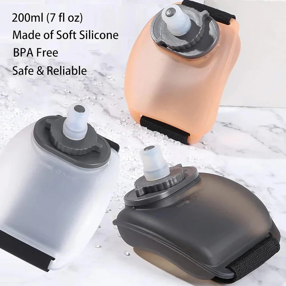 Assorted soft silicone 200ml portable water bottles in translucent, black, and beige, with leakproof caps and adjustable straps, ideal for travel and outdoor use.
