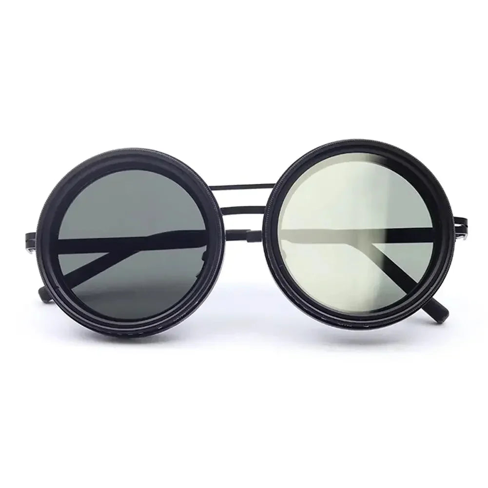 Round black metal sunglasses with double bridge and dark tinted lenses, futuristic streetwear accessory.