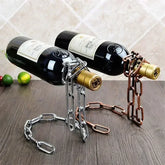 Metal chain wine bottle holders in silver and bronze colors on a wooden surface