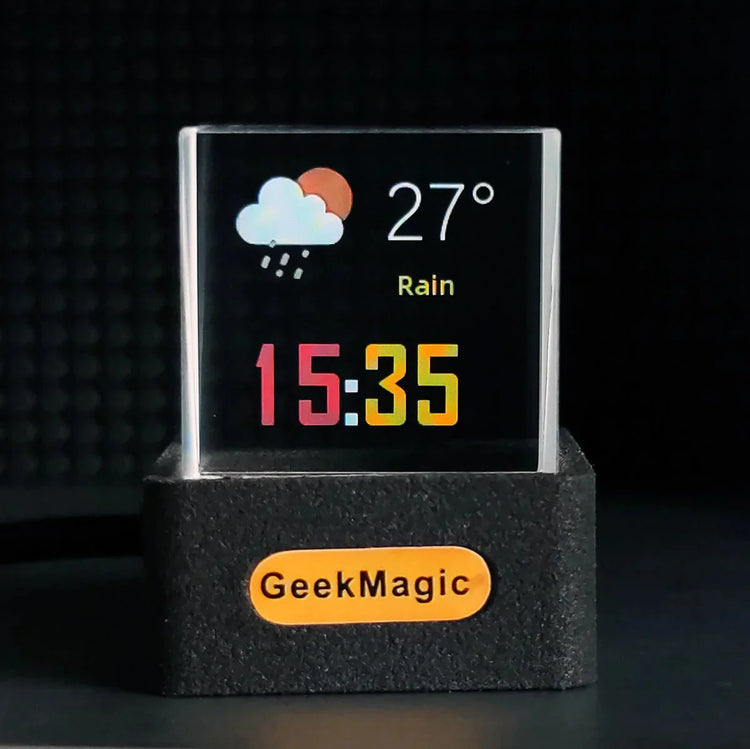 Digital transparent desk clock displaying weather, temperature, and time on a black stand