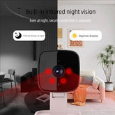 Compact black indoor security camera with visible infrared night vision, modern living room background