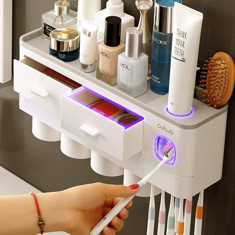 Modern wall-mounted bathroom organizer with white plastic drawers, storage for toiletries, toothbrush holder, and glowing LED accents.