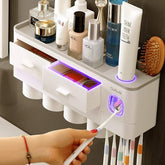 Modern wall-mounted bathroom organizer with white plastic drawers, storage for toiletries, toothbrush holder, and glowing LED accents.