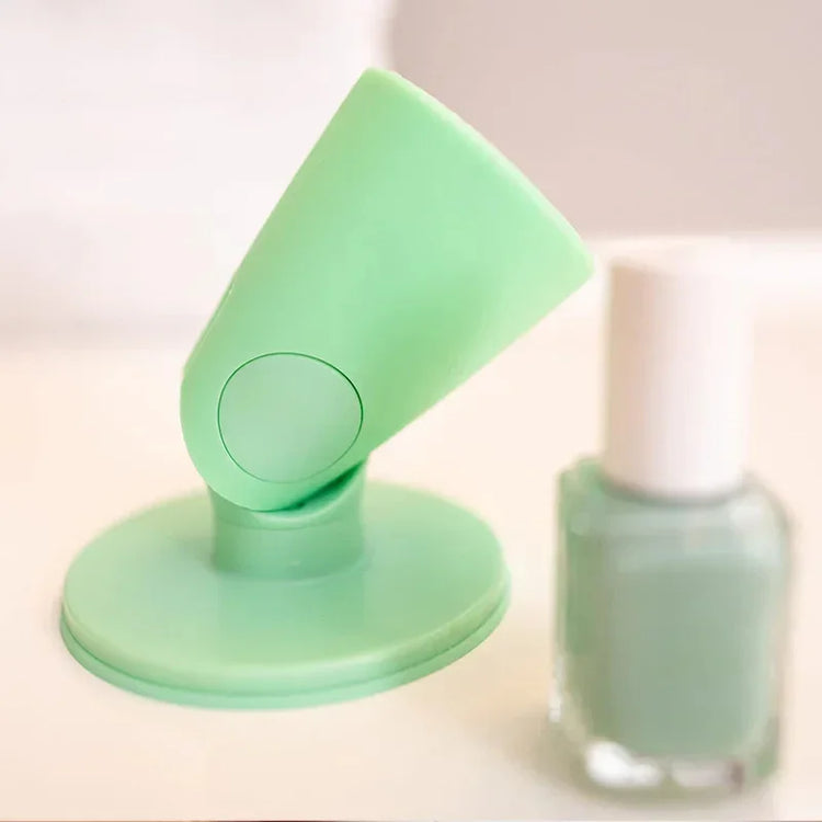 Mint green silicone nail polish holder with matching nail polish bottle on a white surface