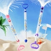 Three colorful water guns spraying on sandy beach, perfect for summer fun and outdoor play
