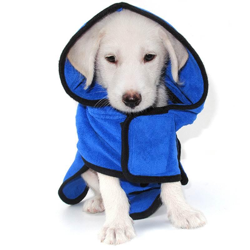 Puppy wearing blue hooded fleece dog robe with black trim, relaxed fit, on white background.