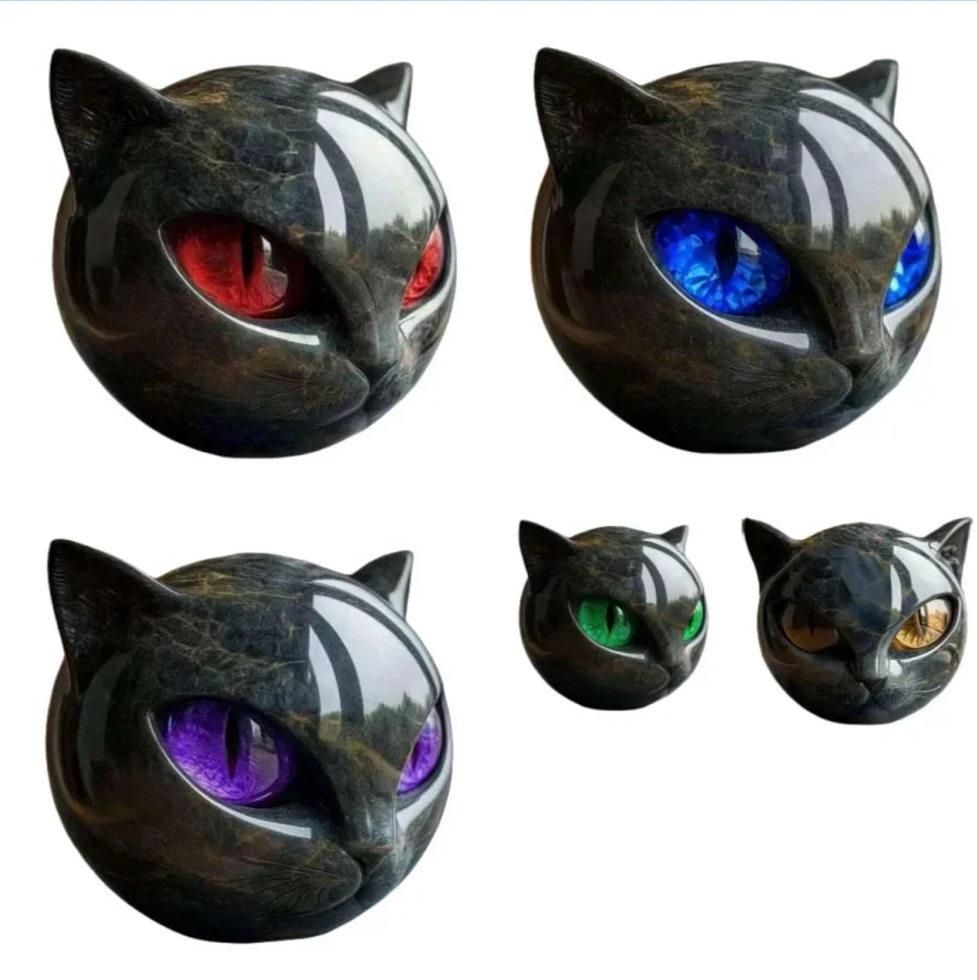 Glossy black cat head figurines with red, blue, purple, green, and gold eyes