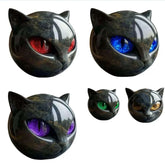 Glossy black cat head figurines with red, blue, purple, green, and gold eyes