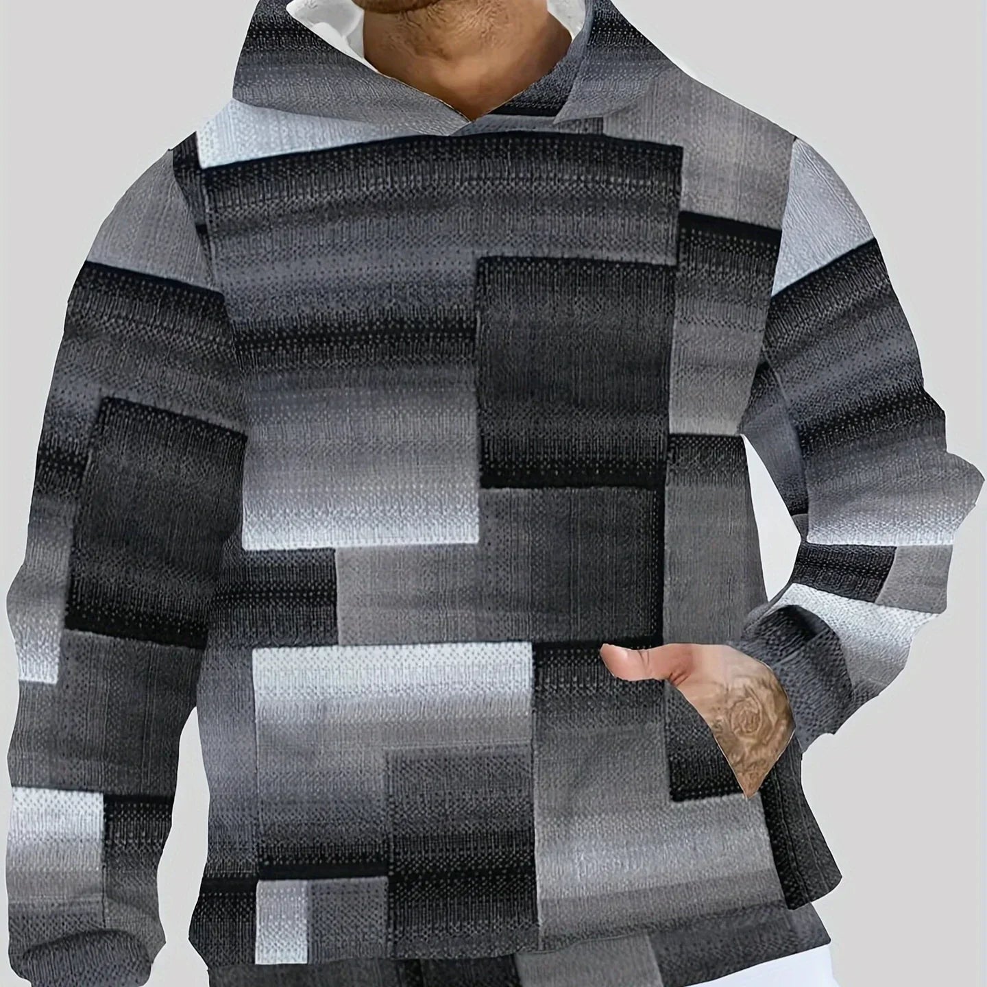 Men's modern streetwear hoodie with black and gray geometric color block pattern, relaxed fit