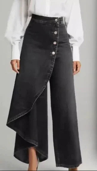 High-waisted black denim wide-leg pants with an asymmetrical draped front panel