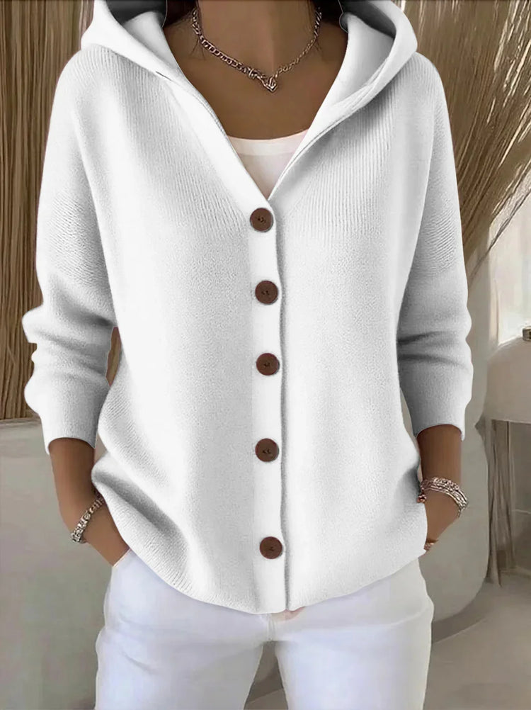 White knit hooded sweater with brown buttons, relaxed fit, long sleeves, casual style.