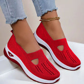 Red knit slip-on sneakers with breathable mesh upper, white sole, casual fit, and cutout design.