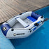 White and blue inflatable boat with oars and cushioned seat floating in a swimming pool