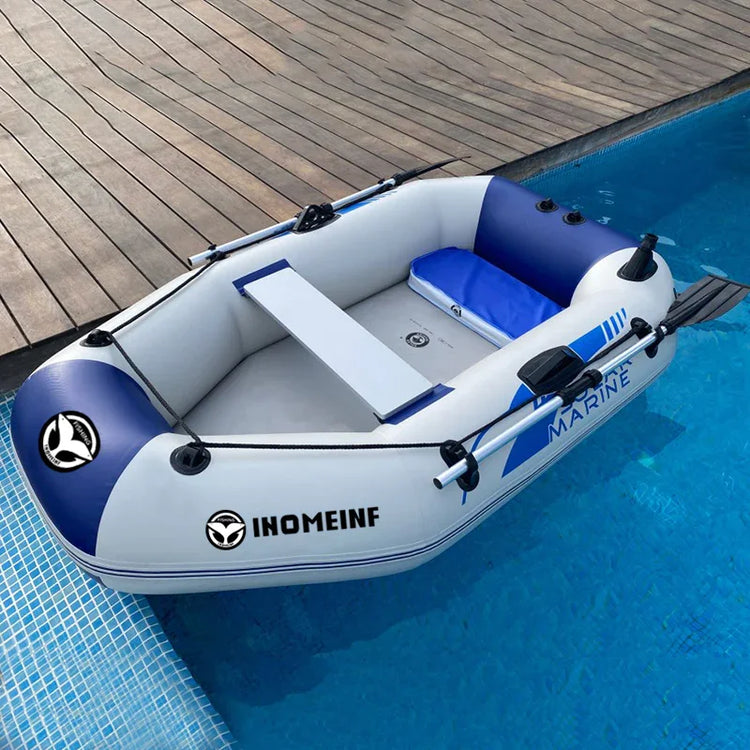 White and blue inflatable boat with oars and cushioned seat floating in a swimming pool