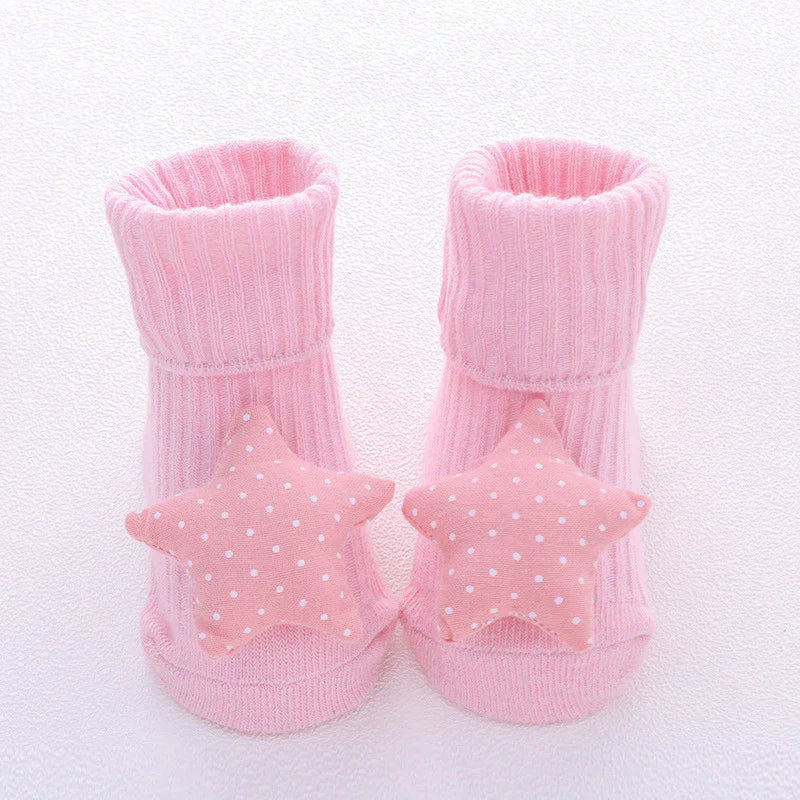 Pink ribbed baby socks with soft star-shaped, polka dot accents, cozy cotton knit.