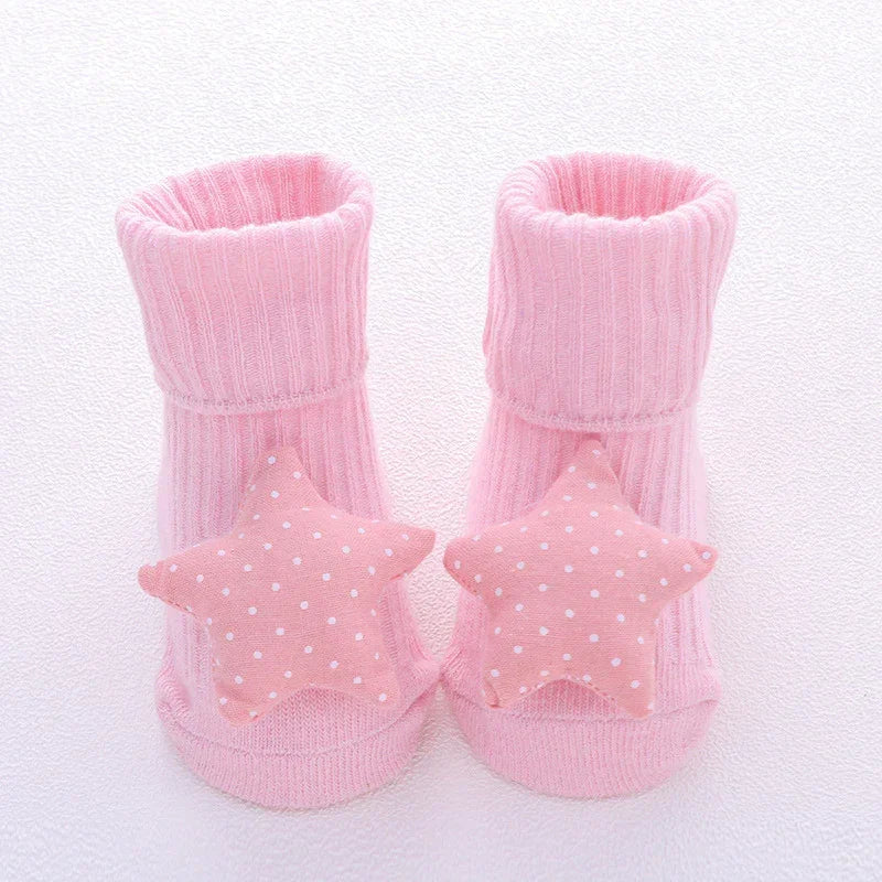 Pink ribbed baby socks with soft star-shaped, polka dot accents, cozy cotton knit.