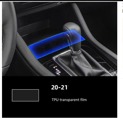 Transparent TPU protective film applied over black leather car gear shift area, modern interior