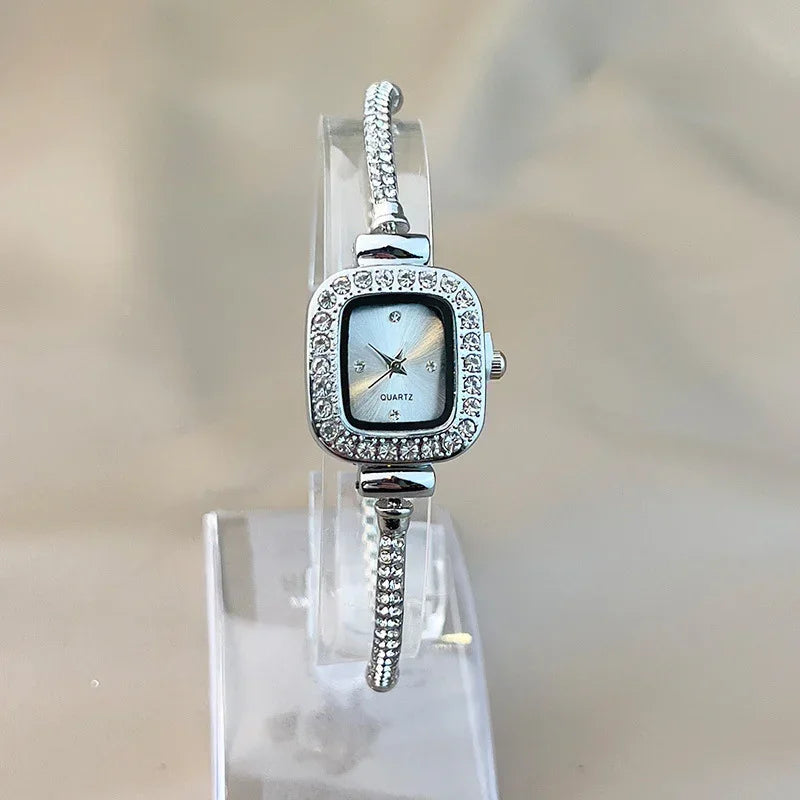 Silver square-faced quartz watch with rhinestone accents and slim bracelet band