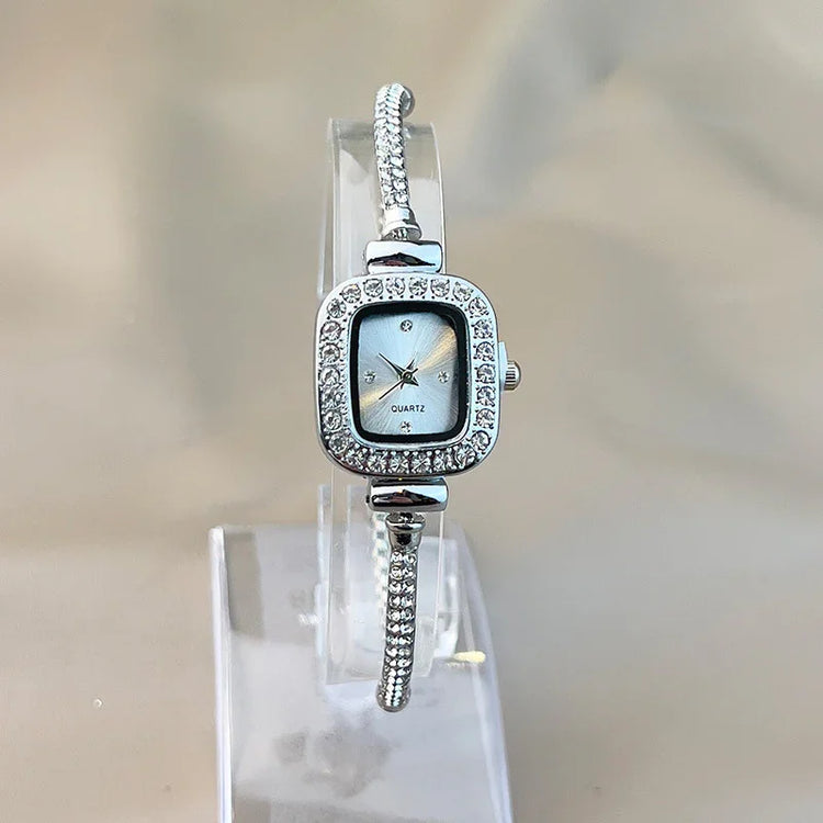 Silver square-faced quartz watch with rhinestone accents and slim bracelet band