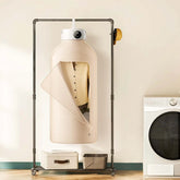 Beige button-up shirt hanging in a garment steamer closet, minimalist laundry room setting