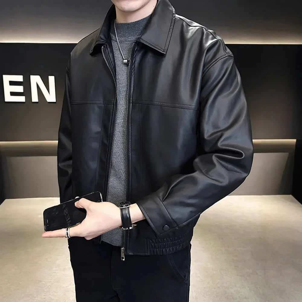 Man wearing black faux leather moto jacket, gray sweater, straight fit, modern streetwear style