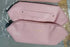 Light pink faux leather pouch with zipper and minimalist design on gray surface