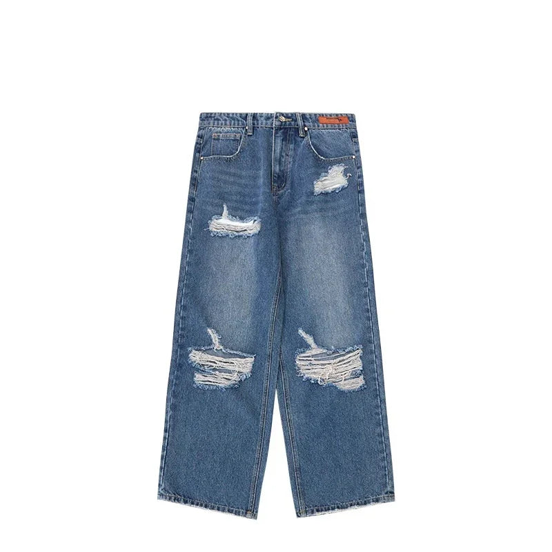 Wide-leg blue denim jeans with heavy distressing and ripped details, relaxed fit.