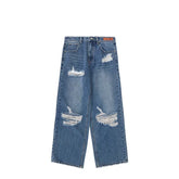 Wide-leg blue denim jeans with heavy distressing and ripped details, relaxed fit.