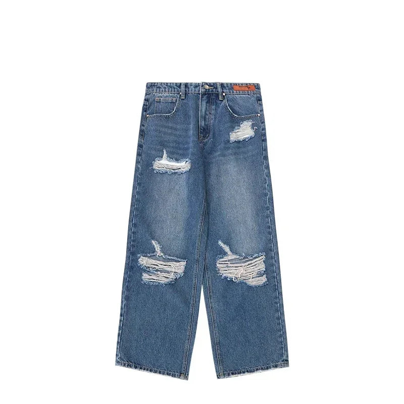 Wide-leg blue denim jeans with heavy distressing and ripped details, relaxed fit.