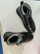 Black leather high-top boots with faux fur lining and lace-up front, winter streetwear style