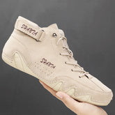 Beige suede high-top sneaker with lace-up front, ankle strap, and neutral rubber sole