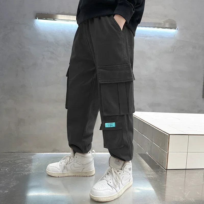 Black cargo pants with oversized pockets, relaxed fit, urban streetwear style