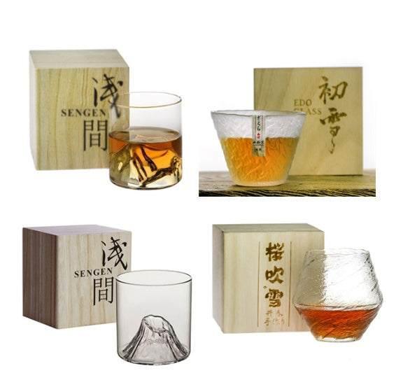 Set of four artisan glass tumblers with textured clear designs and wooden boxes, modern drinkware.