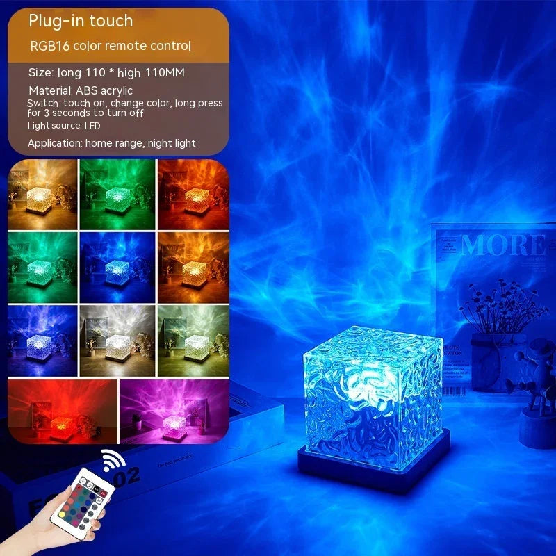 Cube-shaped RGB acrylic LED night light with remote, glowing in blue with multiple color options.