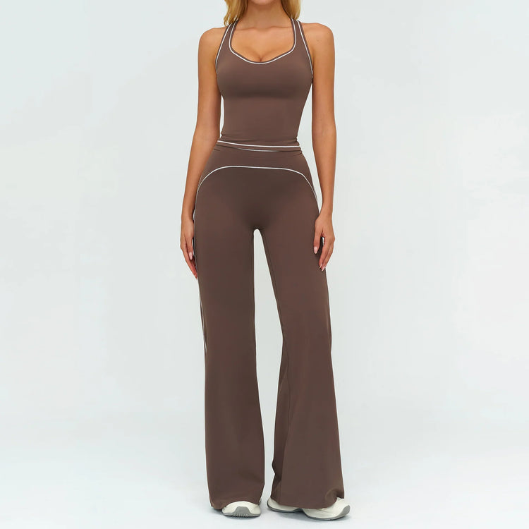 Woman wearing brown fitted tank top and flared pants set with white trim, sporty style.