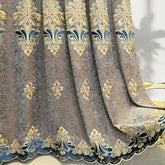 Gray and gold embroidered velvet curtain with blue accents and ornate floral patterns
