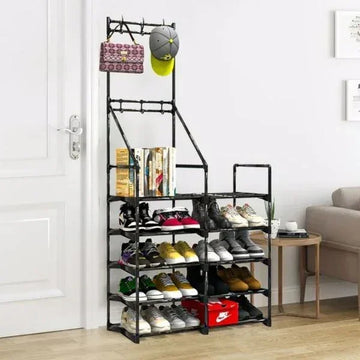 Modern black metal shoe rack with multiple tiers, organized sneakers, books, and accessories in entryway