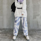 Oversized white graphic hoodie with loose blue and white tie-dye jeans, casual fit streetwear