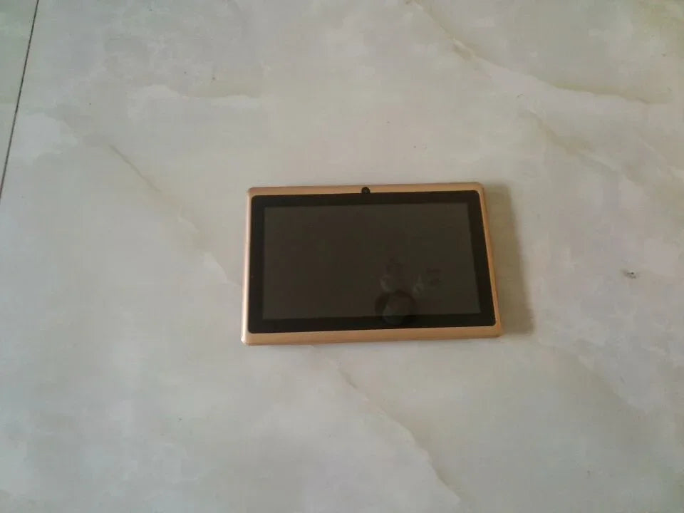 Black and gold tablet device with touchscreen on a light marble surface