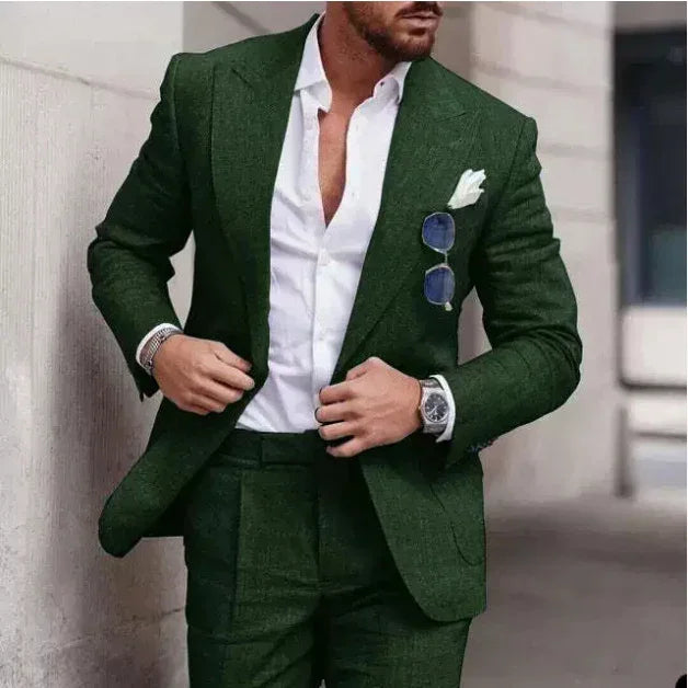 Man wearing slim fit green suit with white dress shirt and pocket square