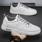 White low-top sneakers with gray laces, faux leather material, and modern streetwear style.