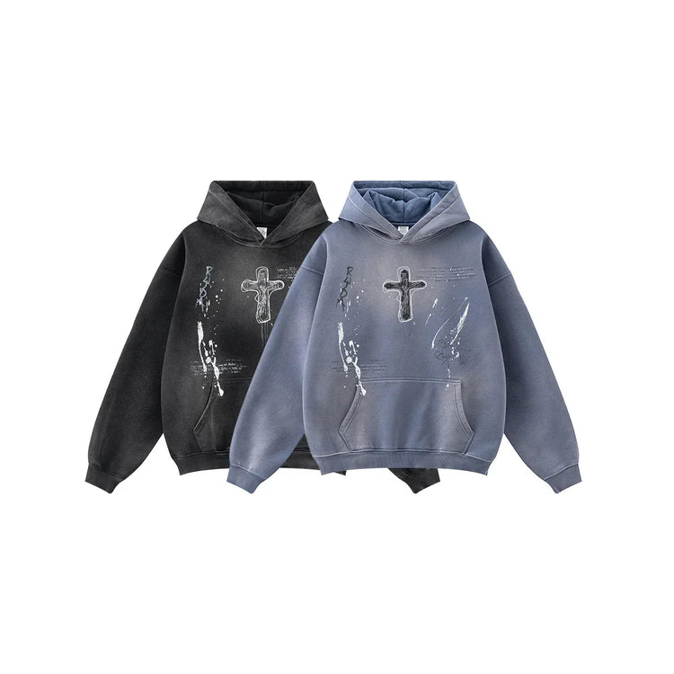 Oversized streetwear hoodies in faded black and blue, featuring cross and paint splatter print.