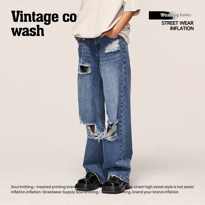 Wide-leg blue distressed jeans with heavy rips, relaxed fit, streetwear style