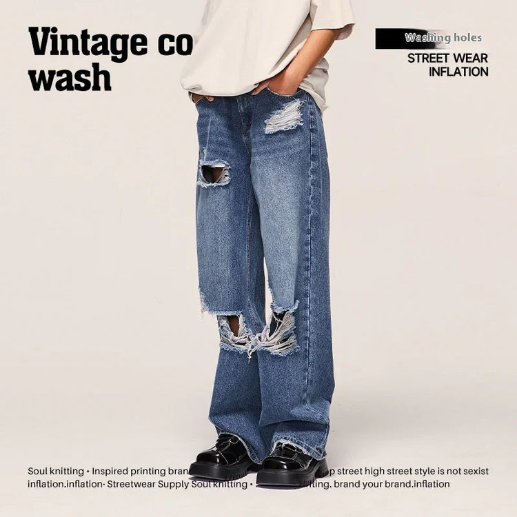 Wide-leg blue distressed jeans with heavy rips, relaxed fit, streetwear style