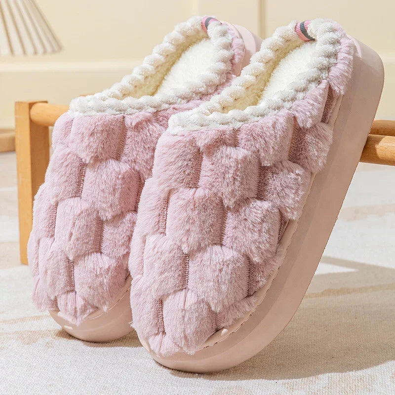 Plush pink slip-on slippers with textured faux fur and soft white fleece lining