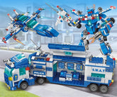 Blue and white police-themed building block set with SWAT truck, robot, and jet in city scene