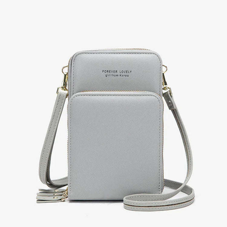 Light grey faux leather crossbody bag with adjustable strap and zip closure, minimalist design
