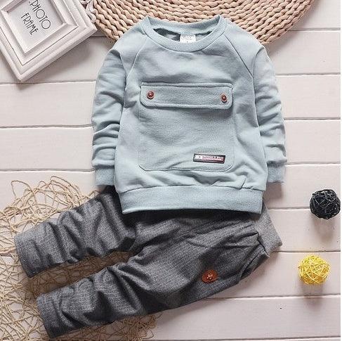 Light blue long sleeve sweatshirt with chest pocket and gray jogger pants, soft cotton blend, relaxed fit.